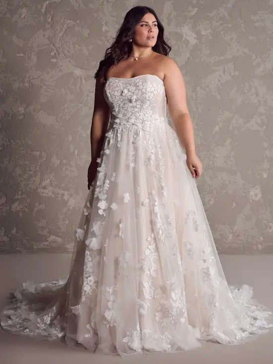 Model is wearing a plus size strapless 3D floral lace wedding dress with a-line silhouette by maggie sottero